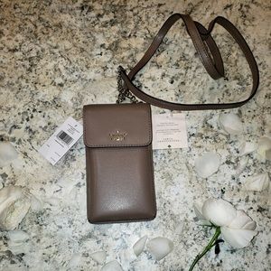 North South pebbled leather cross body bag.